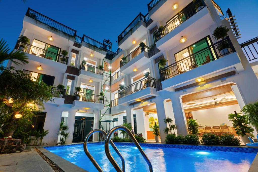 a hotel with a swimming pool in front of a building at Tam Coc Valley Hideaway in Vũ Lâm