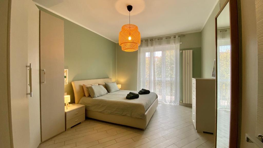 a bedroom with a bed and a pendant light at Collegno Centro - Il Bumbunin... in Collegno