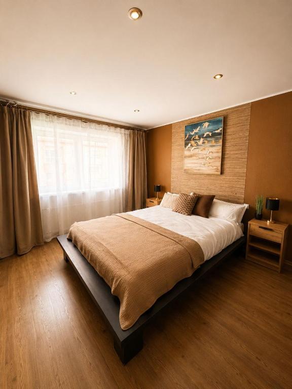 a bedroom with a large bed and a window at Kaare in Uuemõisa