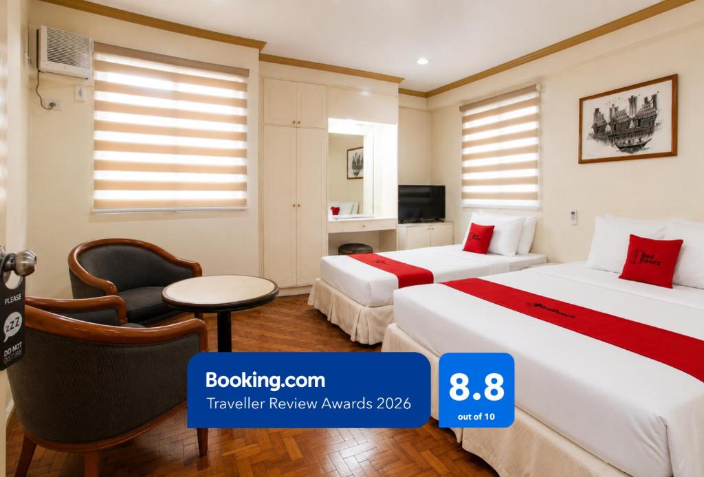 a hotel room with two beds and a chair at RedDoorz @ Tondaligan Beach Hotel in Dagupan