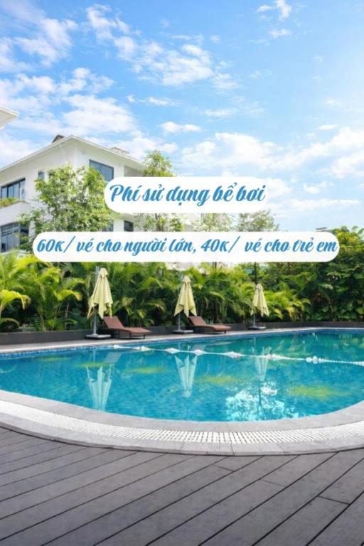 a sign next to a swimming pool with a quote at Sunhouse Villa Huế in Hue