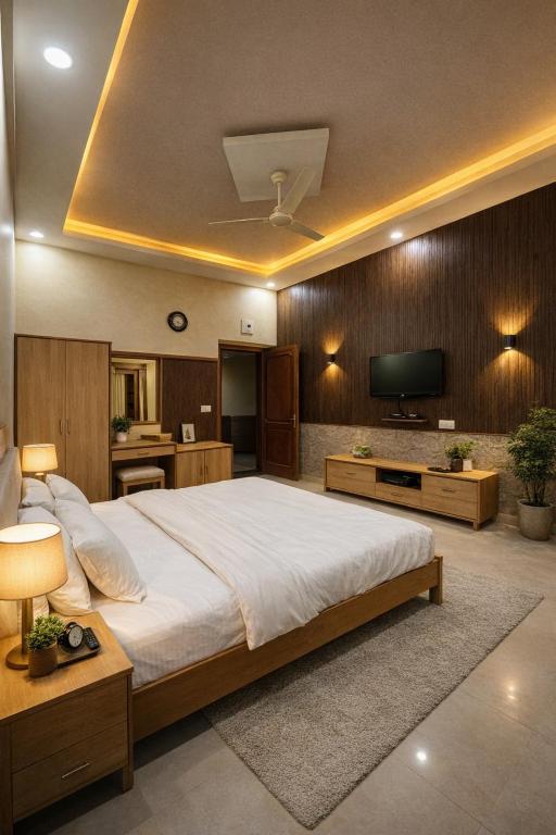 a bedroom with a large bed and a television at Udaigarh Palace - The Heritage Hotel in Jodhpur