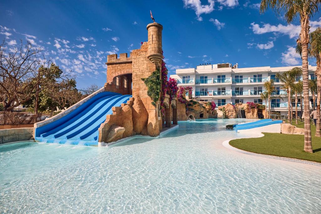 a water slide in front of a resort at Pirates Village in Santa Ponsa