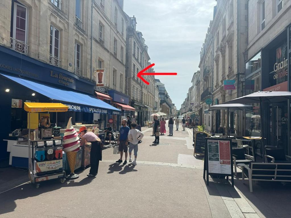 a red frisbee in the air over a city street at Lovely Amour Hyper Centre in Caen