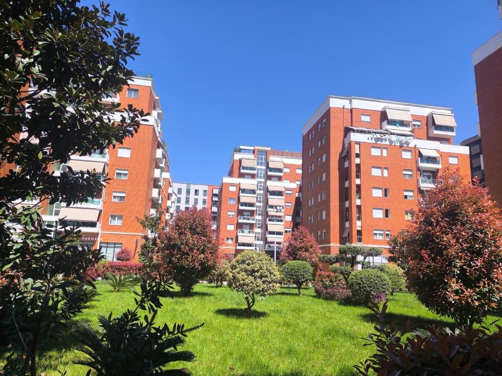 a park in the middle of a city with tall buildings at Astir Apartments in Tirana