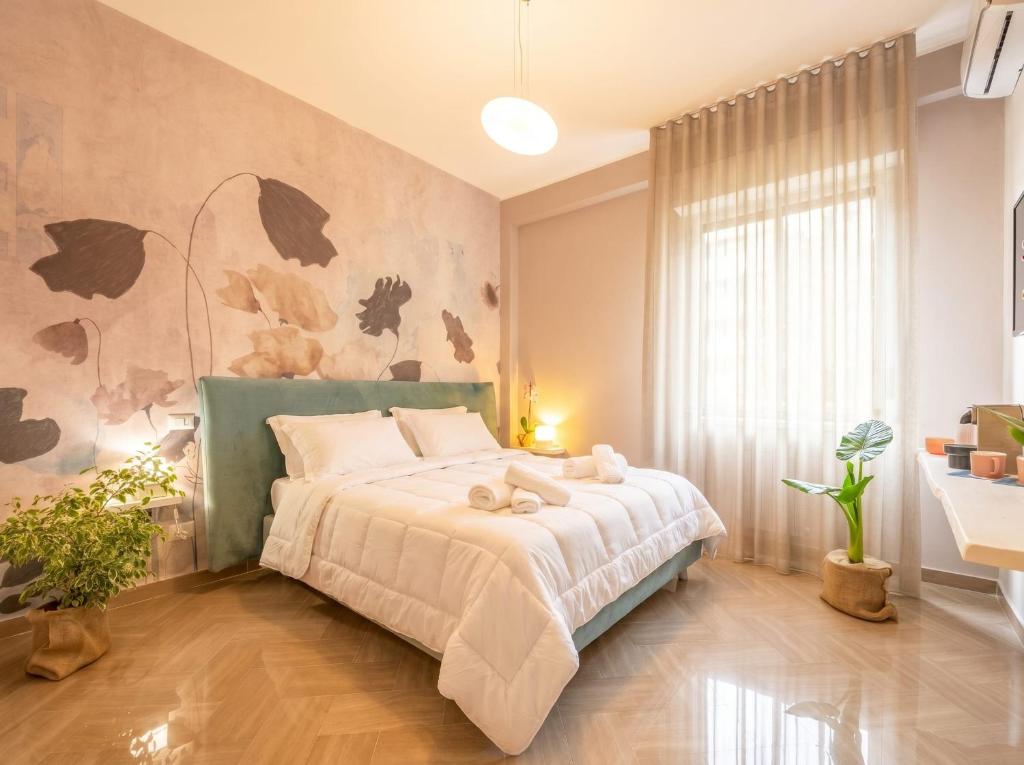 a bedroom with a bed with a white bedspread at City Gate - luxury suites in Bari
