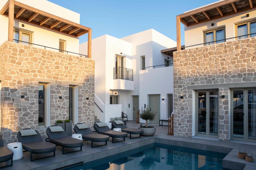 a villa with a swimming pool and a resort at Kalea Suites in Pollonia