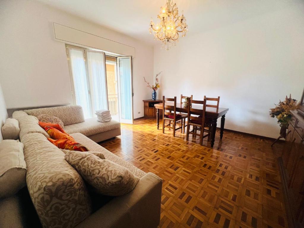 a living room with a couch and a dining room at Suite Excelsior - Bordighera in Bordighera