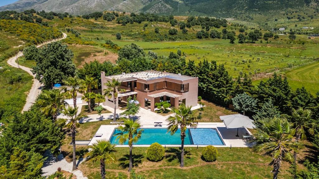 an aerial view of a house with a swimming pool at Fllad e Valë Luxury Private Pool Villa by PikHost in Tragjas