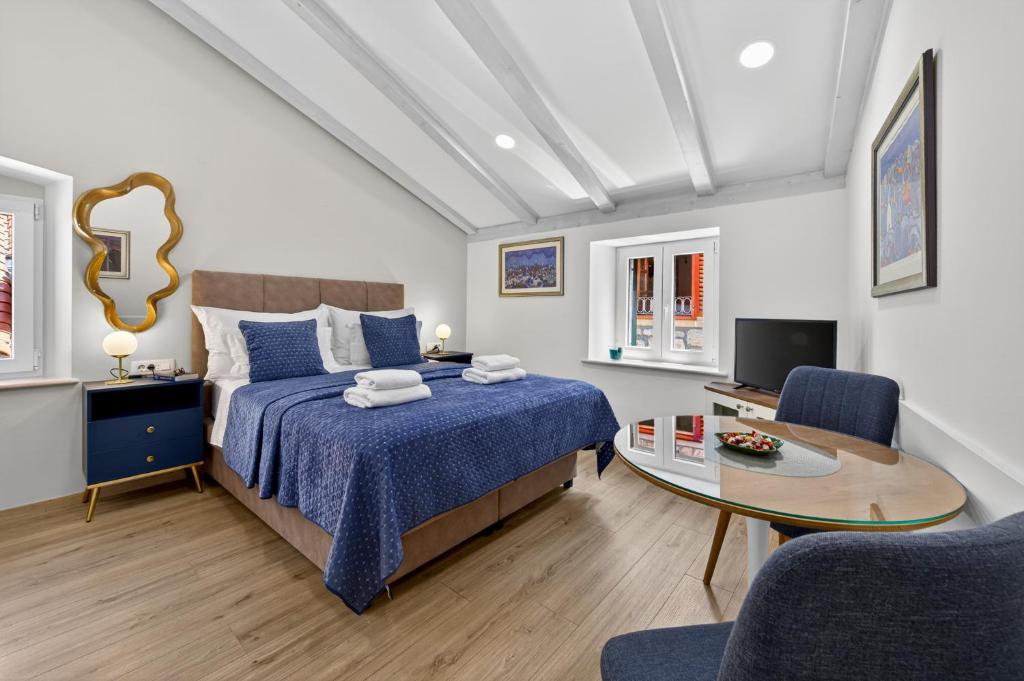 a bedroom with a bed and a table and chairs at Solis Rooms Old Town in Dubrovnik