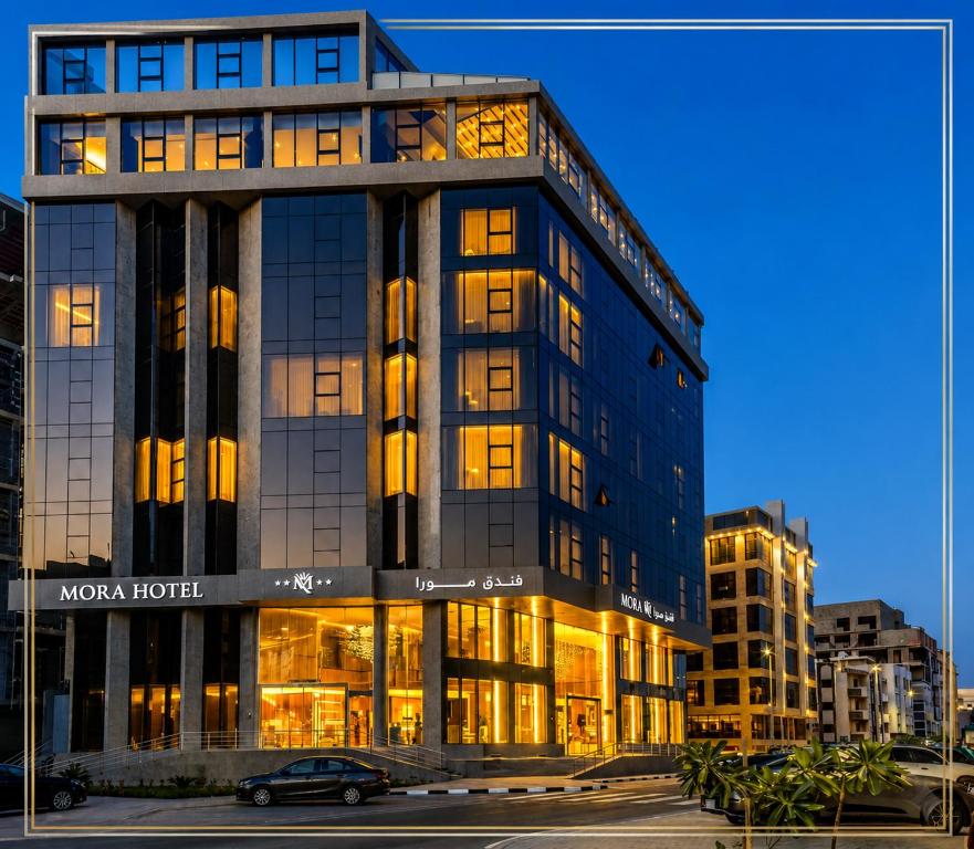 a building with a car parked in front of it at Mora Hotel in Jeddah