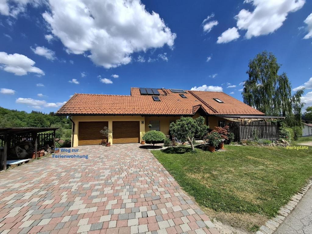 a house with a tile roof and a brick driveway at FW Körner in Zwiesel