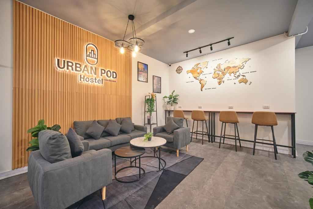 a lobby with a uwegian pod hotel sign on a wall at Urban Pod Capsule Hostel in Bangkok