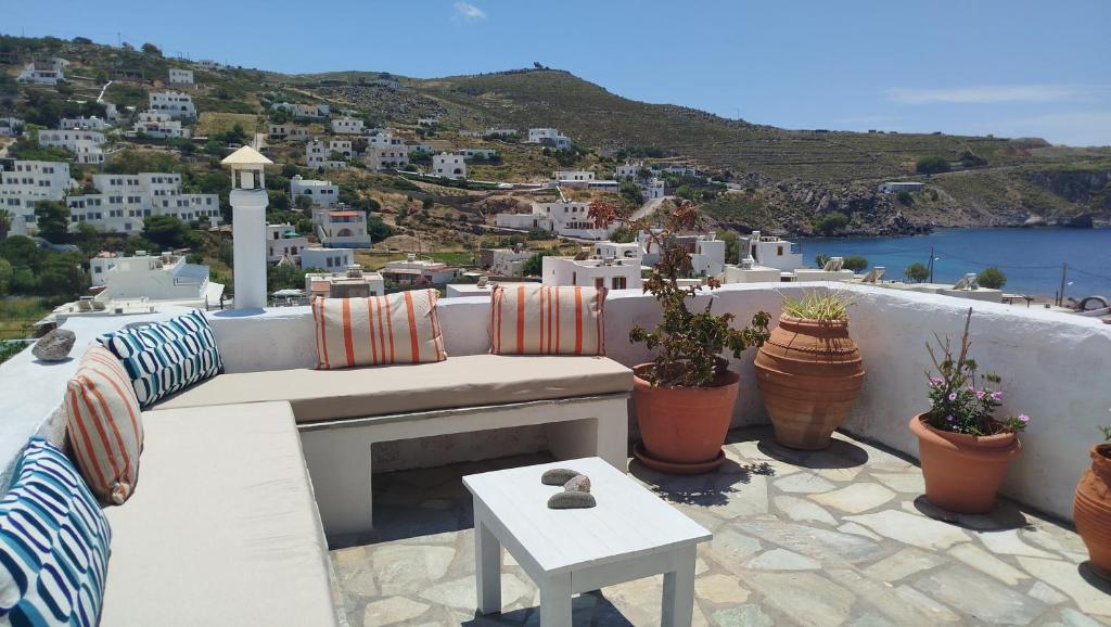 a bench on a balcony with a view of a city at Marietta Studios Patmos in Skala