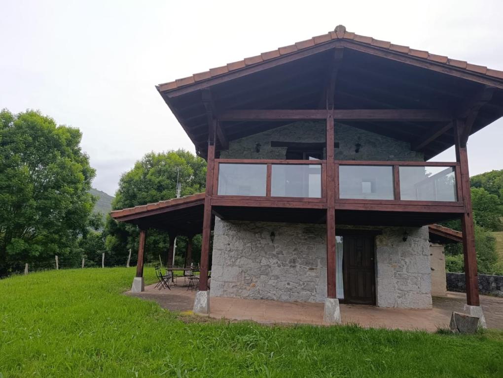 a large building with a deck on top of a field at Casa con encanto in Arredondo