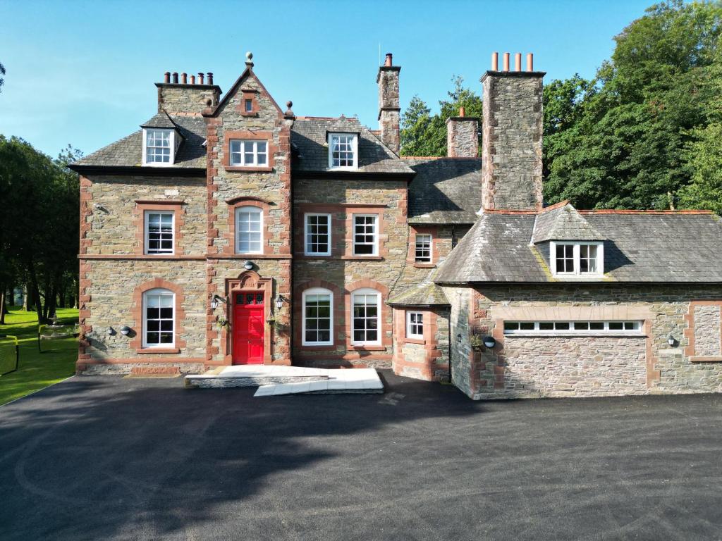 an old brick house with a red door at Dunningwell Hall in Duddon