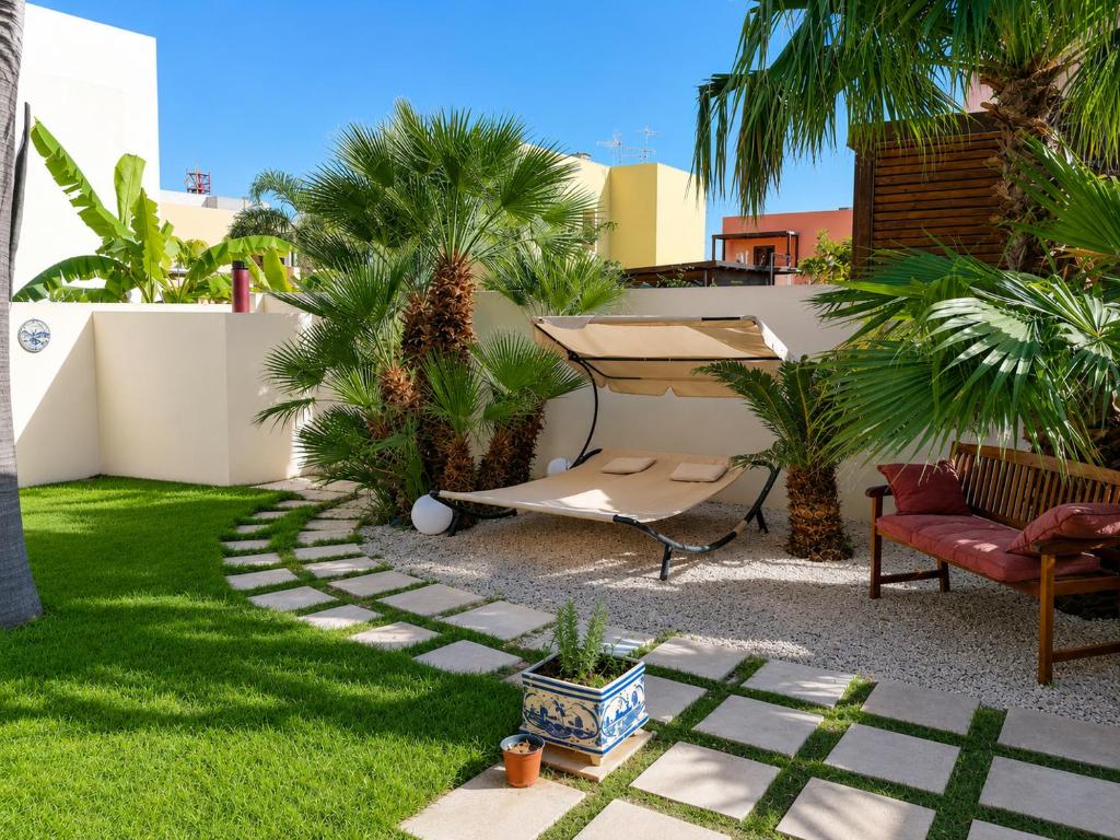 a backyard with a garden with palm trees at Villa Favignana in Favignana
