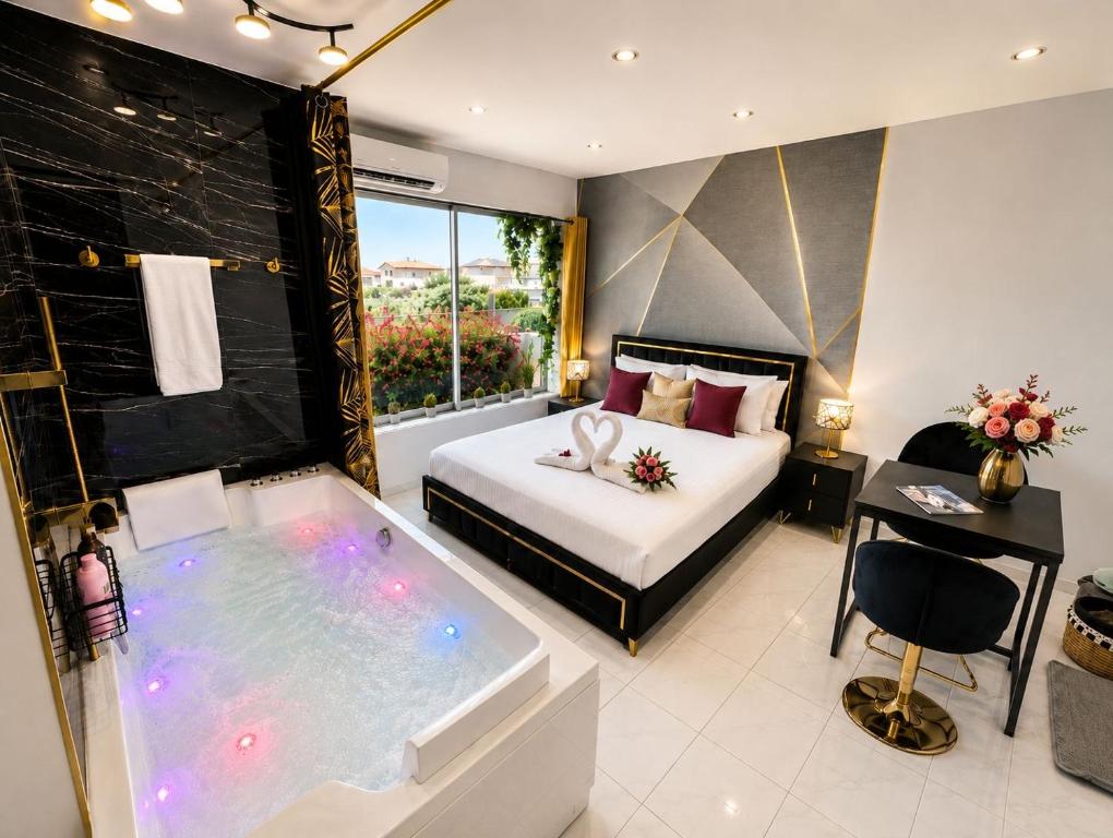 a hotel room with a tub and a bed at Luxury Beach Room in Frontignan