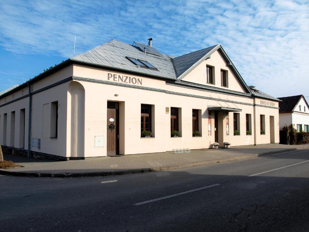 a white building on the side of a street at Obecní dům Mokré Lazce in Opava