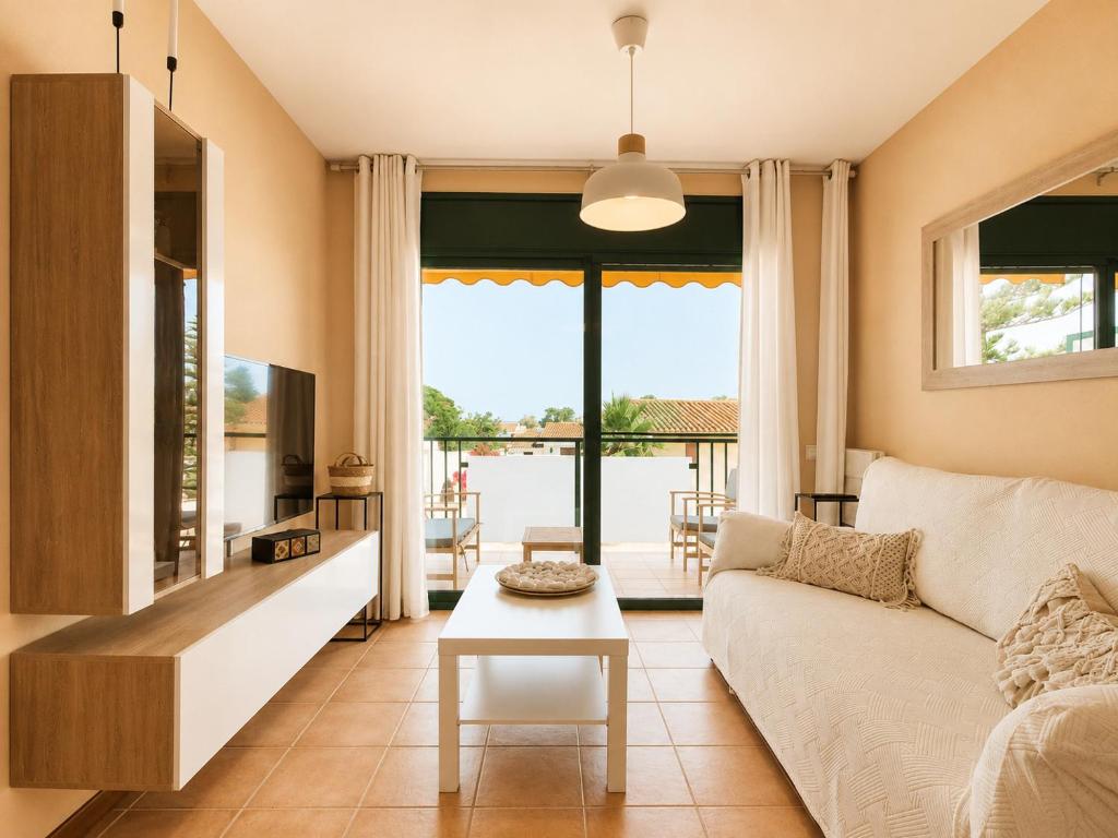a living room with a couch and a table at Apartamento L'Eucaliptus, Delta del Ebro in Amposta