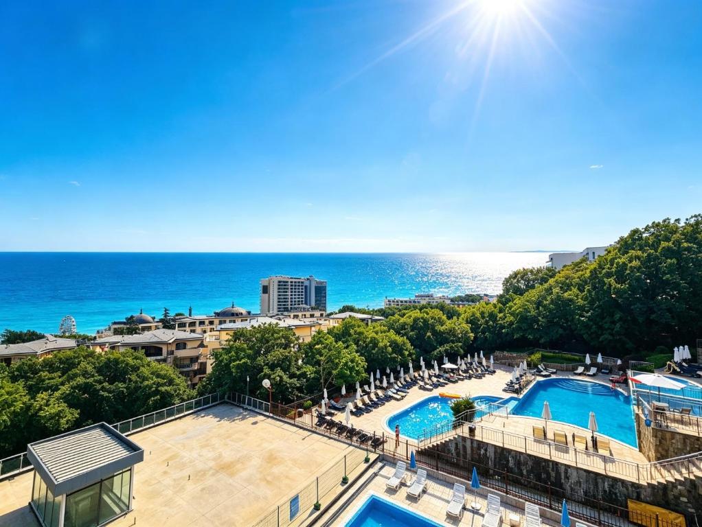 an aerial view of a pool and the ocean at Europroperties Yalta Apartments in Golden Sands