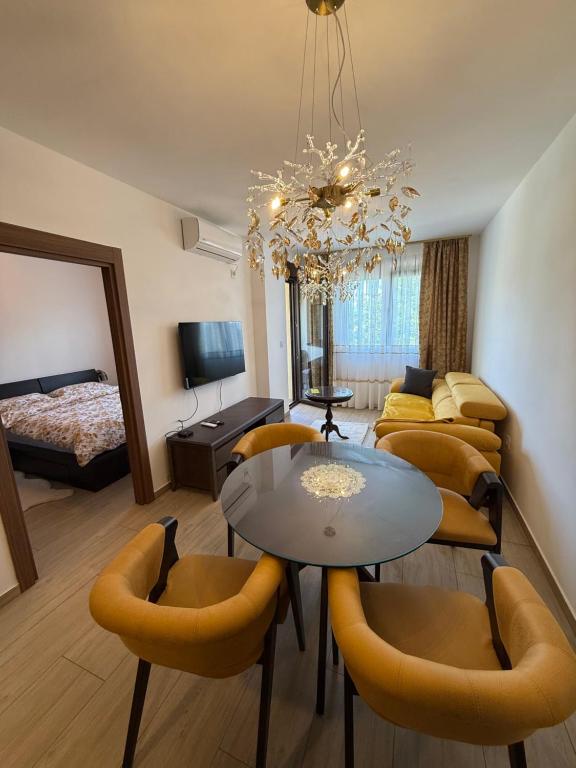 a living room with a dining table and a bedroom at Kokolino in Irig