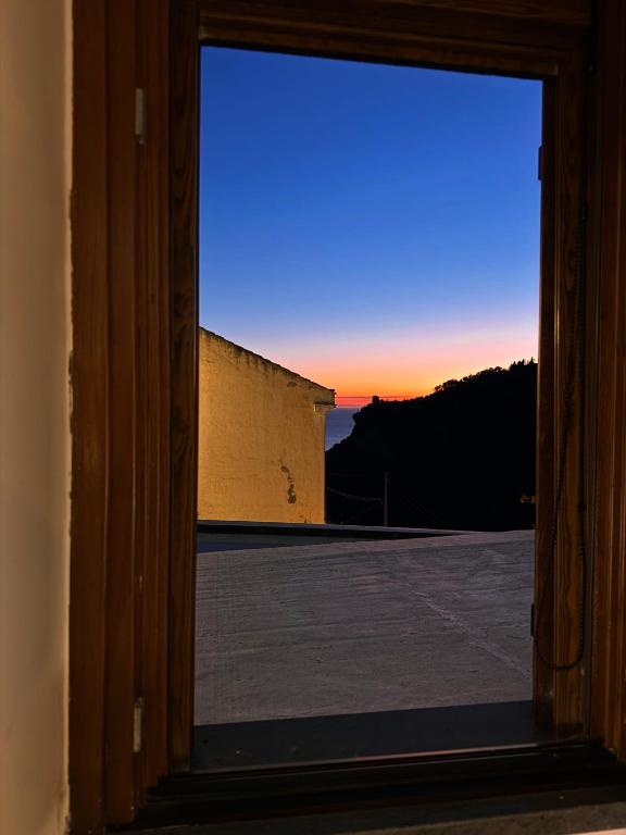 an open window with a view of a sunset at Casa Pont1 Historic Pontone near Amalfi & Ravello in Scala