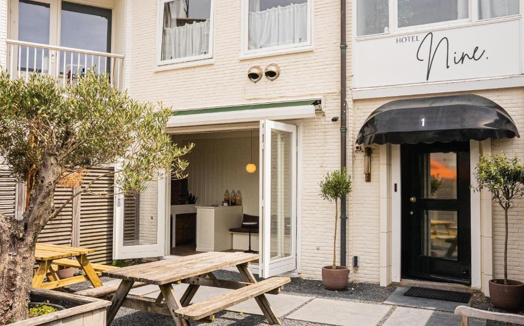 a picnic table in front of a building at Hotel Nine in Zandvoort