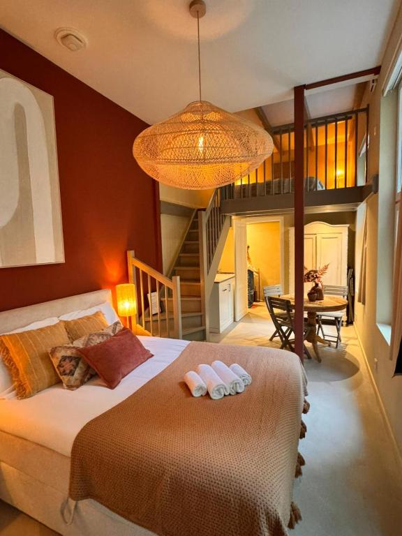 a bedroom with a bed with two towels on it at New monumental garden view Studio in Amsterdam