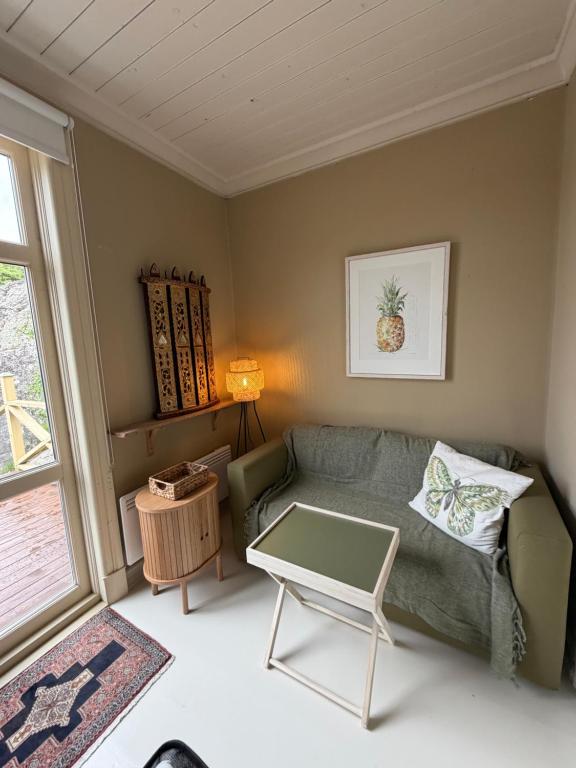 a living room with a couch and a table at Hem till Bengt in Kungshamn