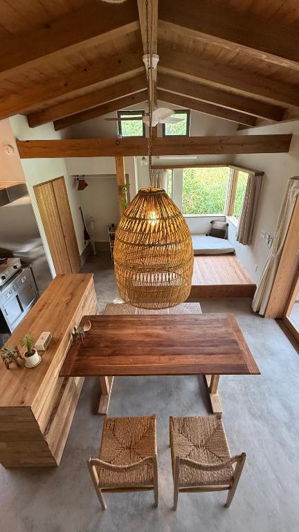 a room with a wooden table and a hanging basket at 月みるいえ in Akaoki