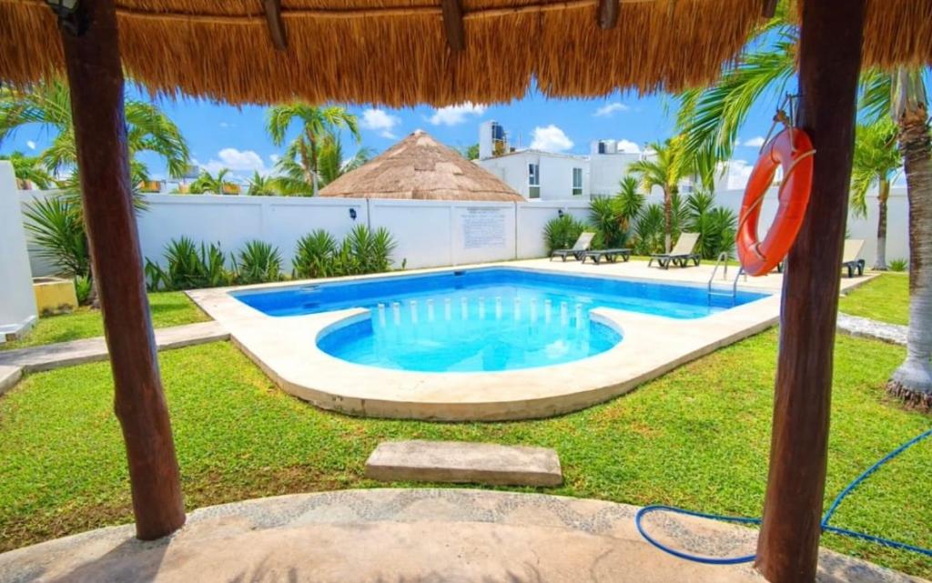 a swimming pool in the yard of a villa at La Casa del Cenote in Playa del Carmen
