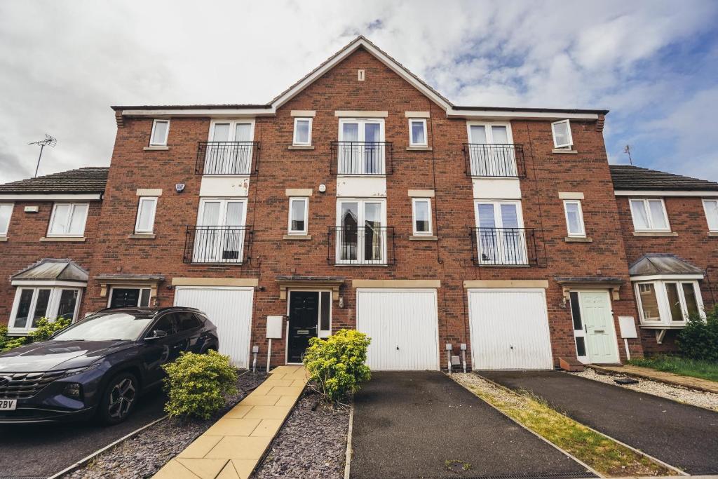 a brick house with a car parked in front of it at 4-Bedroom Family Home in Mickleover - Private Driveway - Spacious Garden in Derby