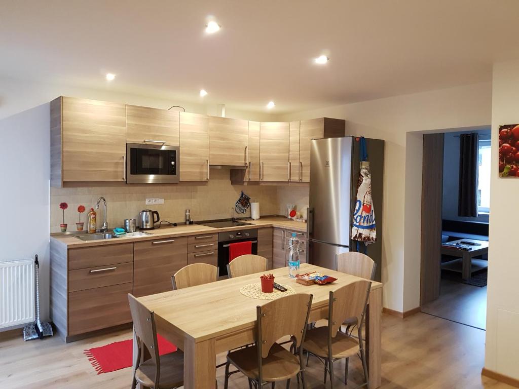 a kitchen with a table and chairs in a kitchen at Apartments Anna and Ondra in Prague