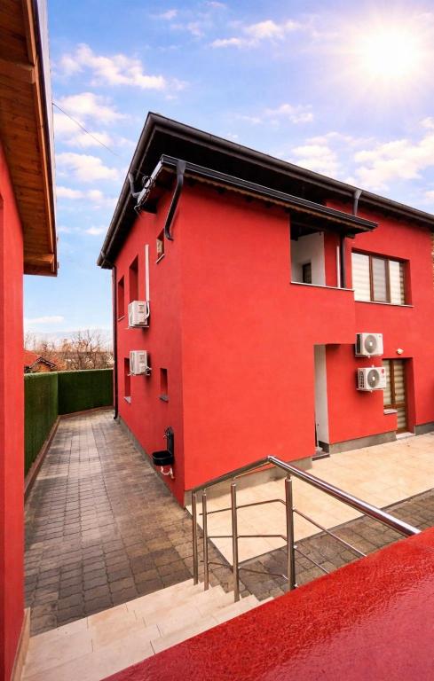 a red building with a ramp in front of it at Червената къща in Hisarya