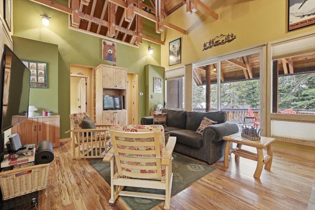 a living room with a couch and a table at A-Frame Home with Deck & BBQ - VH223 cabin in Bear Valley