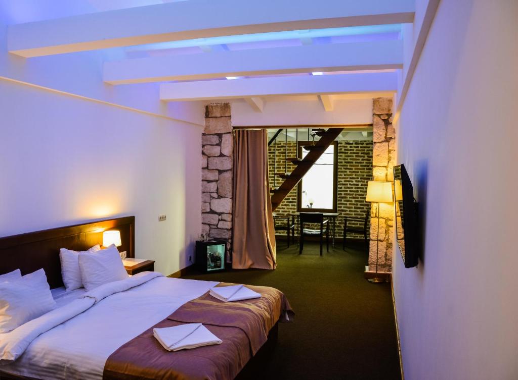 Postel nebo postele na pokoji v ubytování DEM Hotel