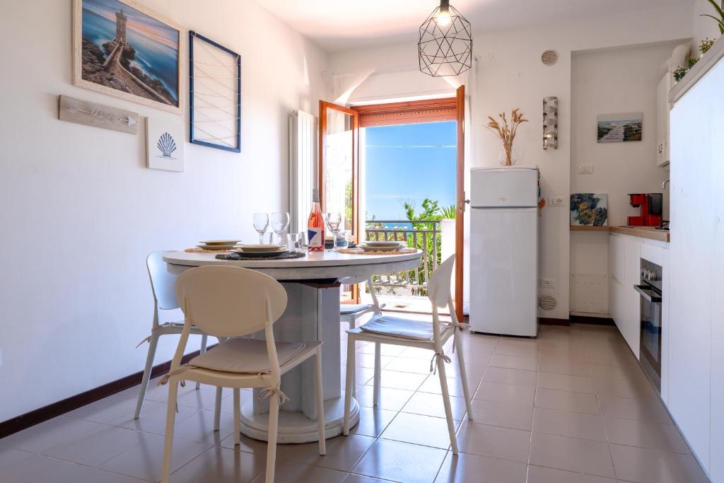 a kitchen with a table and chairs and a refrigerator at Altea in Fossacesia