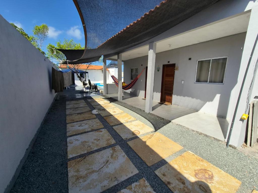 a patio of a house with a hammock on it at Descanso das Águas in Santo Amaro