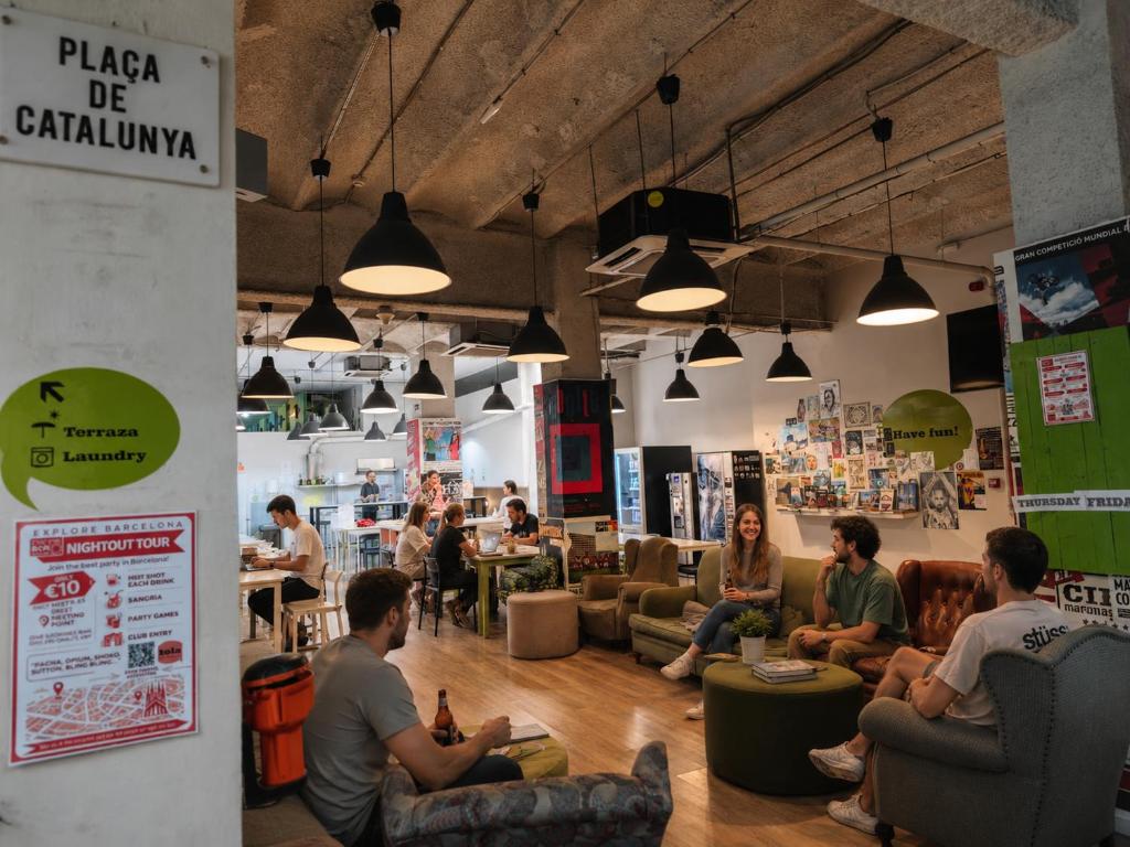 a group of people sitting in a room at Hola Hostal Eixample in Barcelona