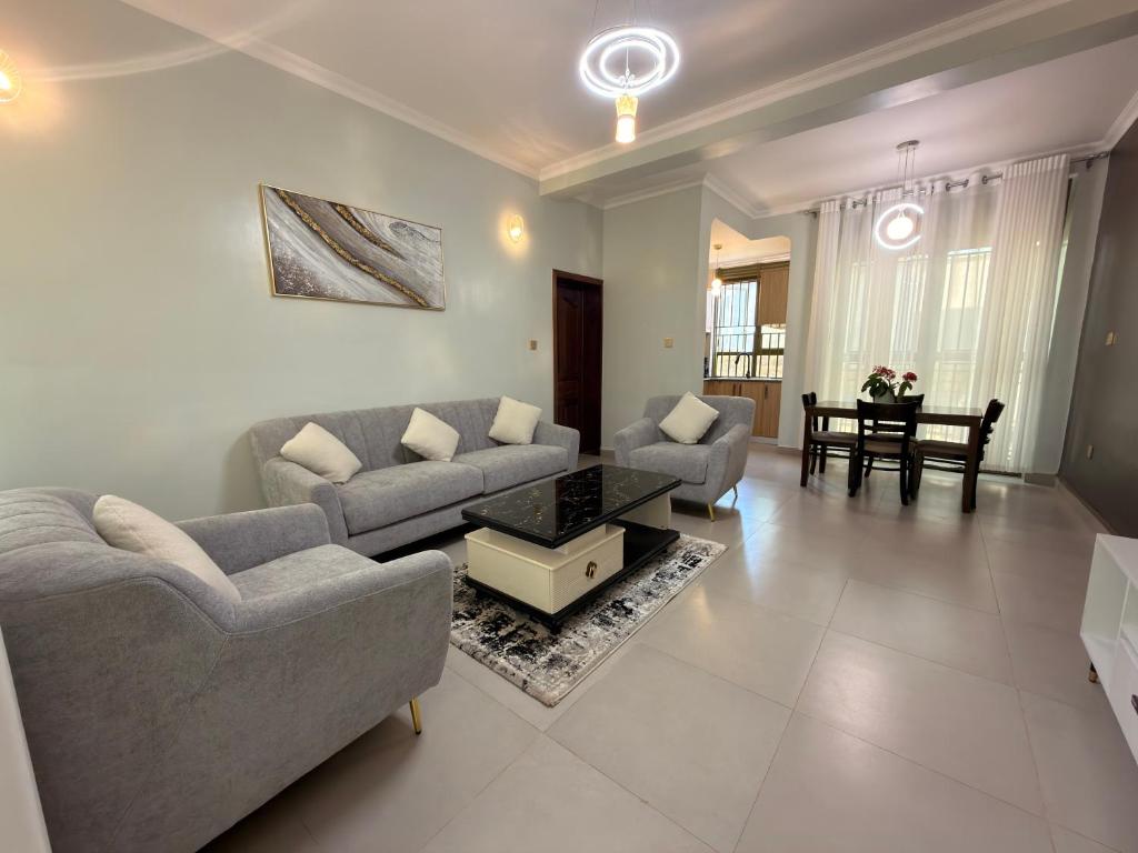 a living room with two couches and a table at Elite Apartments Masaka in Kigali