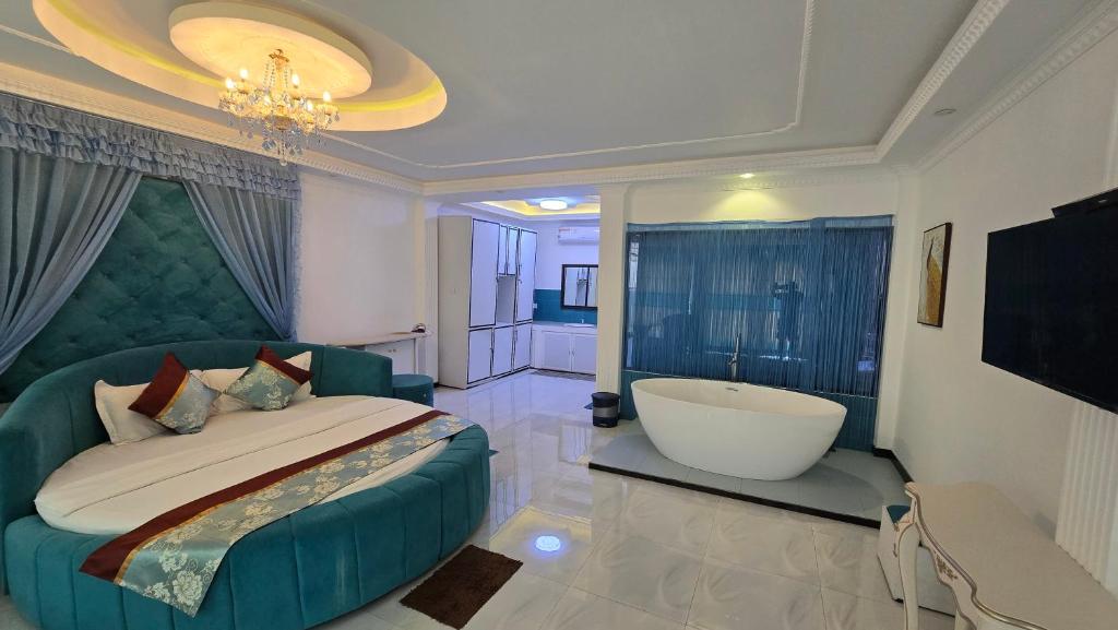 a bedroom with a large bed and a bath tub at Golden Ridge Sigiriya in Dambulla