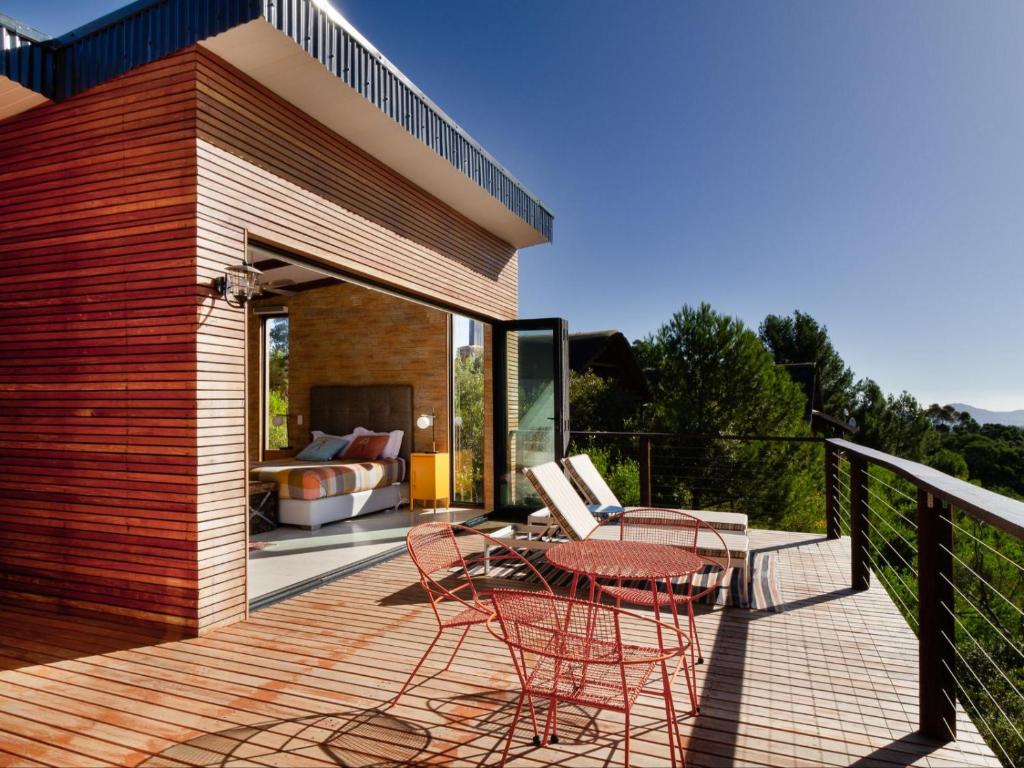 a deck with chairs and a table and a couch at Mountain Bungalow private hot tub&swimming pool in Wolseley
