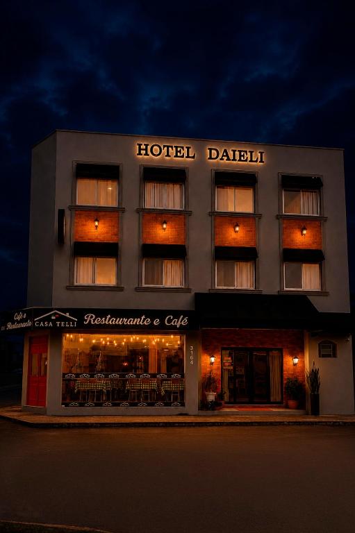 a hotel dabitz with tables and chairs in front of it at Hotel Daieli in Otacílio Costa