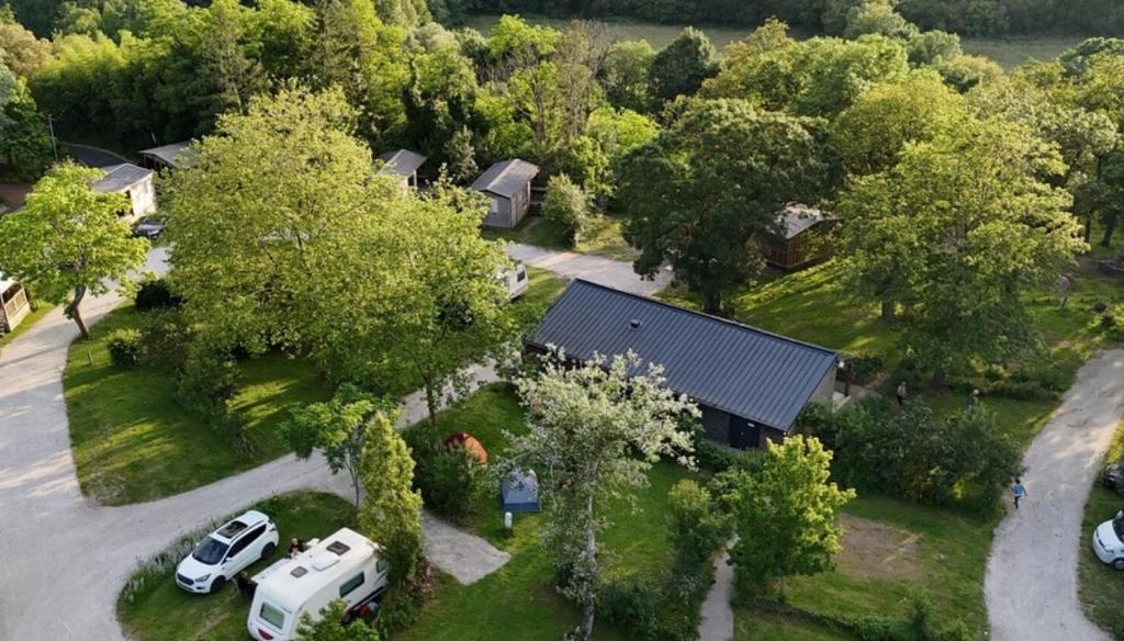 an aerial view of a house with cars parked in a driveway at Camping Onlycamp du Moulin in Clisson