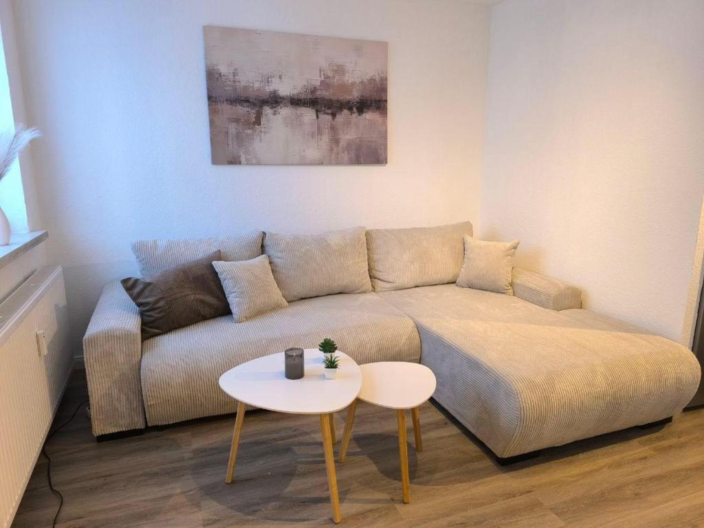 a living room with a couch and a table at Ferienwohnung-Heide-3 in Walsrode