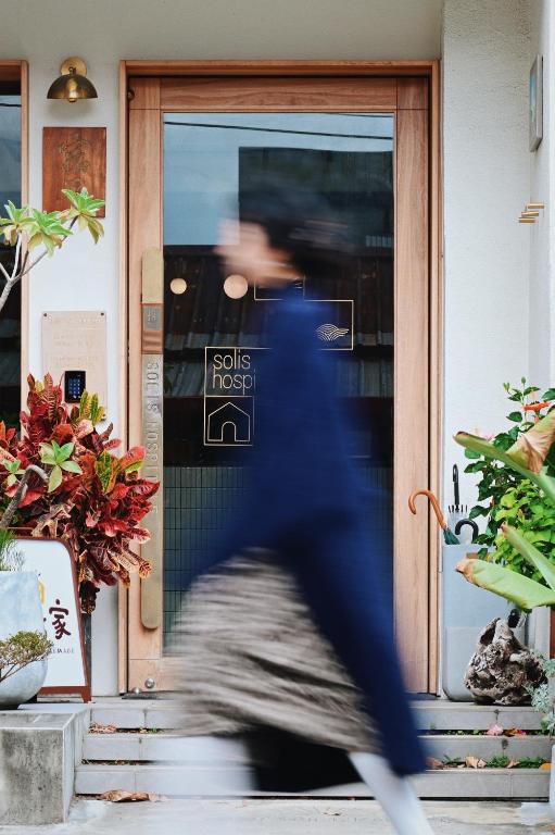 a person walking in front of a door at Sōlis Inn 宿里旅行舍 in Hualien City