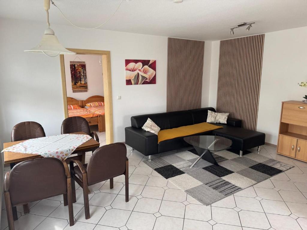a living room with a couch and a table at Anjas Ferienwohnung Buchenrod in Flieden