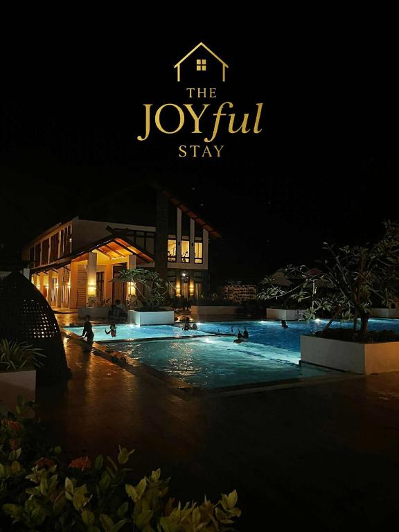 a sign that reads the joule gui stay at night at The JOYful Stay in Mactan Island