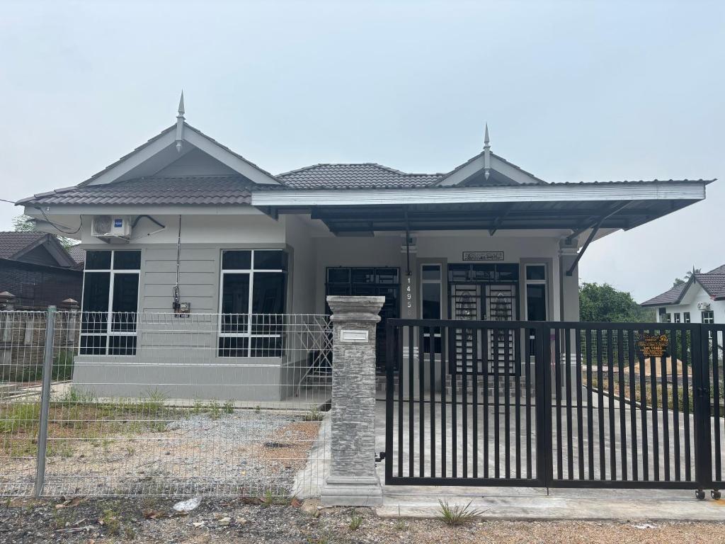 a house with a gate in front of it at D Teratak Homestay in Marang